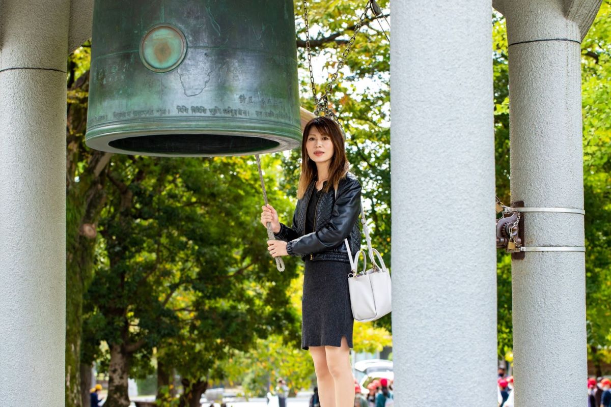 A woman ringing the bell of peace in Hiroshima
